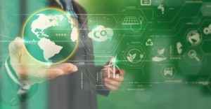 Hand holding a digital globe surrounded by eco-themed technology icons, symbolizing the balance between innovation and environmental sustainability.
