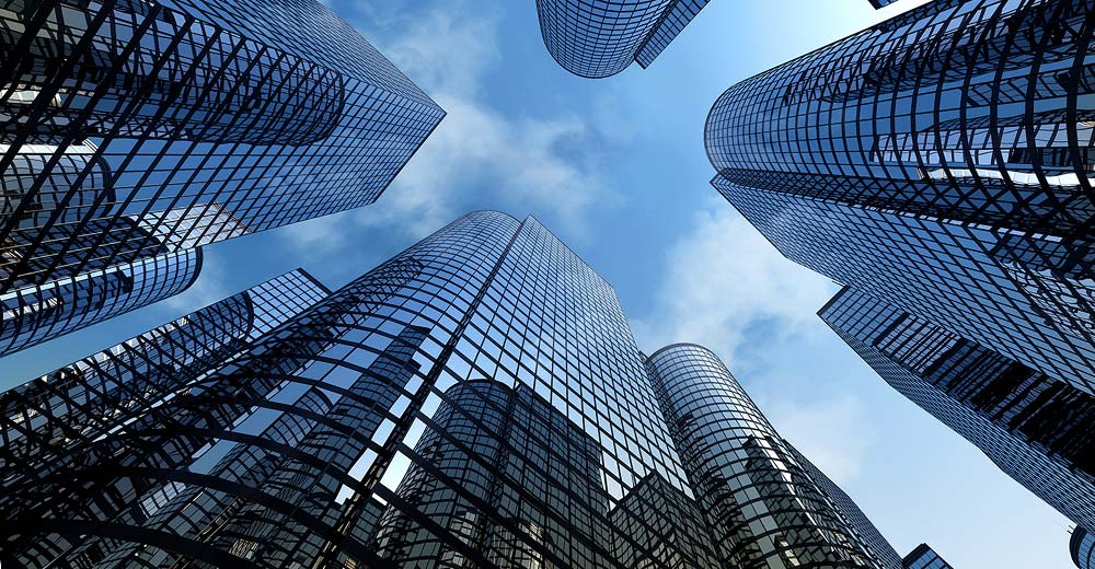 Glass office towers symbolizing corporate real estate adoption of AI technology.