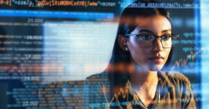 Female AI specialist analyzing cybersecurity data on screen, representing how artificial intelligence supports short-staffed security teams.