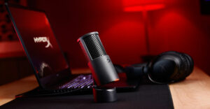 HyperX headset and SoloCast 2 microphone on a desk with HP gaming laptop in the background.