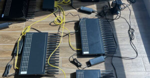 Seized SIM farm devices with multiple antennas and power cables, used in a large telecom threat network dismantled by the U.S. Secret Service in the New York City metro area.