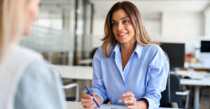 HR leader in conversation with an employee in a modern office setting