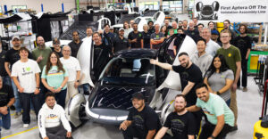 Aptera team with the company’s first solar electric vehicle on the validation assembly line in Carlsbad, Calif.