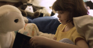 A child interacts with an AI-powered robotic companion designed for emotional engagement and household interaction.