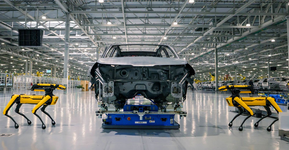 Boston Dynamics robot dogs inspect a vehicle body at Hyundai Motor Group Metaplant America in Georgia.